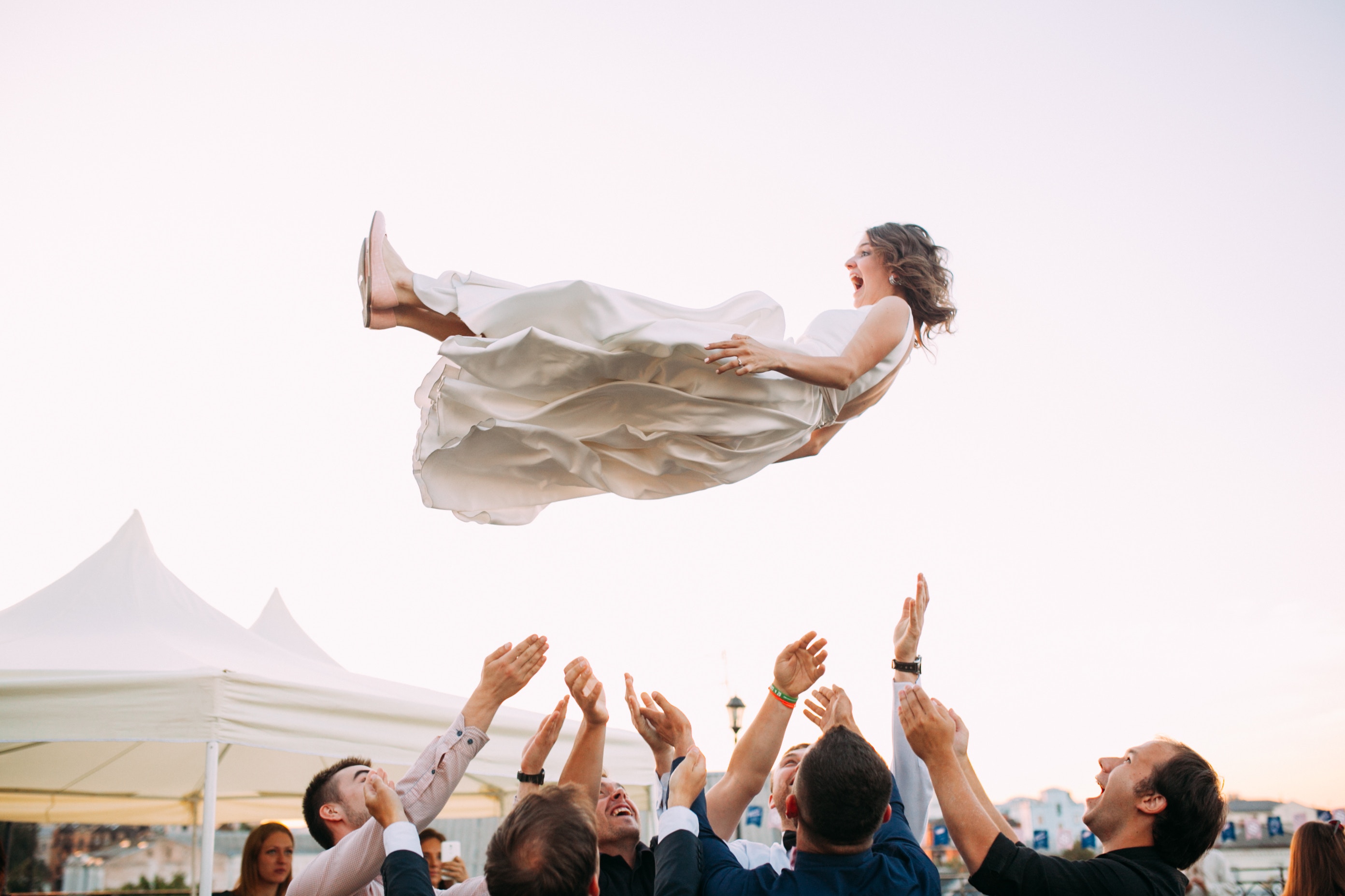 New wife thrown in the air as part of the wedding celebration. Brooklyn Dance Lessons bridesmaids package.
